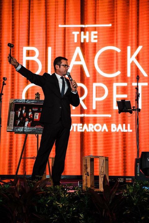 Raising the hammer at a Black Tie ball