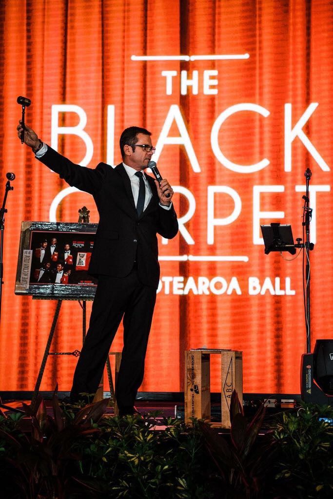 Shaun McEwan raising the hammer at a charity gala