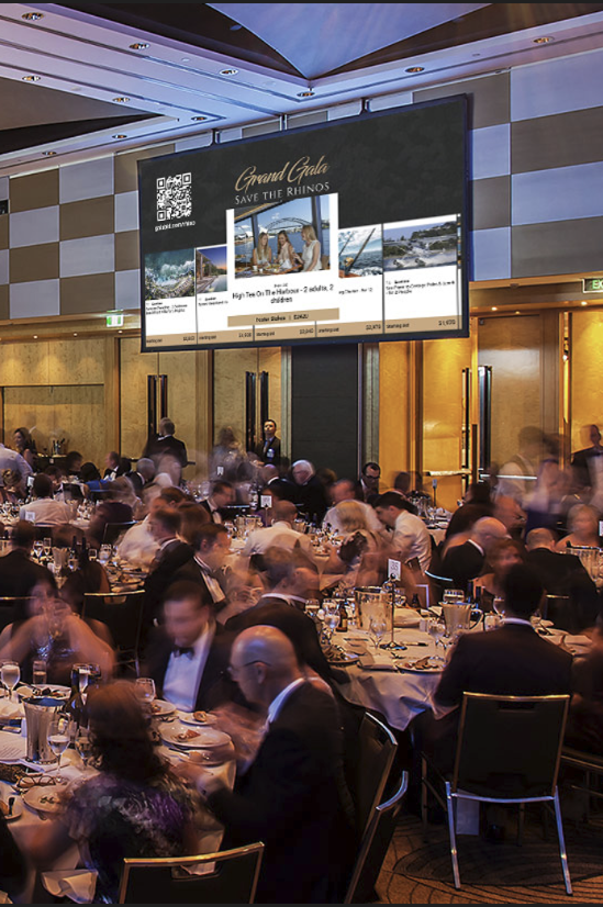 Guests bidding at a live auction